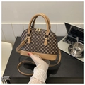 Détail du sac coquille montrant le motif floral rétro et les bretelles en cuir de qualité - Kaki