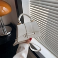 Elegant white litchi pattern PU leather trapezoid handbag with a vintage gold metal bar - White