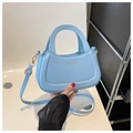 Detail of light blue PU leather handbag showing golden hardware and detachable strap - Blue