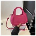 Detail of a magenta half-moon bag featuring gold lettering and detachable shoulder strap - Rose Pink