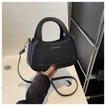 Detail of black crossbody bag with round handle and gold 'FASHION & BAGS' text - Black