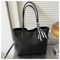 Detail of minimalist black tote bag with decorative black and white striped silk scarf handle - Black