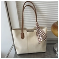 Detail view of cream white tote bag with vertical stitching and checkered scarf accessory - White