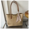 Detail of beige tote bag with decorative silk scarf and thin brown shoulder straps - Khaki