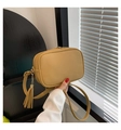Detail of yellow pebbled leather crossbody bag with decorative tassel and gold hardware - Khaki