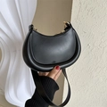 Minimalist black crescent shoulder bag with smooth finish and gold hardware details - Black
