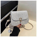 Detail of silver pleated crossbody bag featuring a golden horseshoe metallic buckle clasp - White