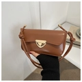 Detail of caramel faux leather bag featuring a golden triangular metal twist lock - Tan