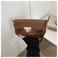 Detail of a brown leather shoulder bag featuring a unique gold triangle buckle closure - Dark Brown