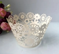 Close-up of laser-cut cream cupcake wrapper featuring intricate floral daisy patterns - 5cm / Starry White