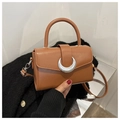 Detail of vintage dark brown handbag with a crescent moon silver buckle and handle - Tan
