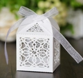 Elegant white laser-cut wedding favor box with intricate hollow design and silver ribbon - White