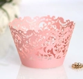 Detailed laser-cut pink paper cupcake wrapper featuring intricate floral lace patterns - Pink