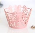 Macro detail of pink laser-cut cupcake wrapper with reindeer and snowflake lace pattern - 5cm / Pink