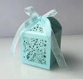 Close-up of light blue laser-cut candy box with star patterns and organza ribbon - Tiffany Blue