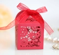 Detail of red laser-cut candy box with floral patterns and a matching organza ribbon bow - Pearlescent Red