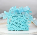 Close-up of light blue laser-cut snowflake gift box with elegant matching ribbon bow - Tiffany Blue