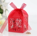 Close-up of red laser-cut candy box with hollow butterfly patterns and silk ribbon bow - Pearlescent Red