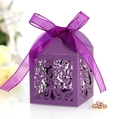 Macro shot of laser-cut butterfly patterns and purple silk ribbon on wedding candy box - Dark Purple