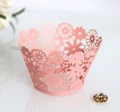 Close-up of laser-cut pink paper cupcake wrapper with intricate floral lace pattern - 5cm / Pink