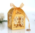 Elegant gold hollow laser-cut wedding favor box with a delicate satin ribbon bow - Gold