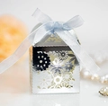 Silver laser-cut hollow floral wedding favor box with a light blue satin ribbon bow - Reflective Silver