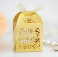 Macro detail of laser-cut floral pattern on yellow glitter paper wedding favor box - Gold