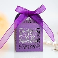 Macro shot of purple laser-cut candy box with floral pattern and silk ribbon bow - Dark Purple