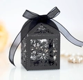 Detailed close-up of a black laser-cut snowflake gift box with an elegant ribbon bow - Black