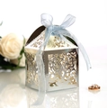 Macro shot of silver hollow gift box with blue ribbon bow for wedding celebrations - Reflective Silver