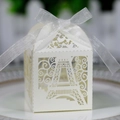 Detail of white laser-cut Eiffel Tower candy box with an elegant ribbon bow - Ivory