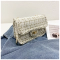 Classic tweed plaid flap bag in cream white with gold chain strap on denim - Off White