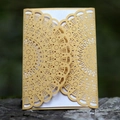 Intricate gold laser-cut hollow invitation with white inner card on natural stone base - Gold