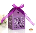 Macro detail of laser-cut purple gift box with floral pattern and satin ribbon bow - Dark Purple