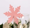 Detail of pink snowflake place card with pearlescent texture on a wine glass rim - Pink