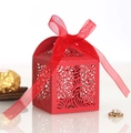 Detail view of red laser-cut candy box with elegant scroll patterns and ribbon - Pearlescent Red