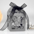 Macro detail of laser-cut snowflake patterns on a pearlescent grey gift box with ribbon - Silver Charcoal