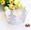 Macro shot of white castle laser cut cupcake wrapper with a sparkling floral rhinestone detail - White