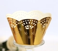 Detailed macro shot of laser-cut golden rose lace pattern on cupcake paper wrappers - Reflective Gold