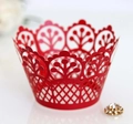 Detailed close-up of red laser-cut cupcake wrappers with crown patterns for wedding decor - Pearlescent Red