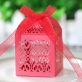 Macro shot of red laser-cut wedding favor box with an elegant organza ribbon bow - Pearlescent Red