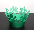 Macro detail of laser-cut green snowflake cupcake wrapper for Christmas baking decor - Fruit Green