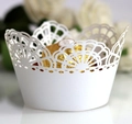 Macro view of white laser cut lace cupcake wrappers with intricate floral patterns - 5cm / White