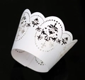 Exquisite white laser-cut cupcake wrappers with elegant damask lace pattern on black background - White