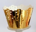 Detail showing golden laser-cut cupcake wrappers with intricate floral lace patterns - Reflective Gold