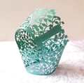 Detail of mint green laser-cut cupcake wrapper with elegant hollowed leaf pattern - Tiffany Blue