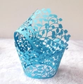 Close-up of sky blue laser-cut cupcake wrappers with intricate leaf and vine patterns - Sky Blue