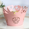 Pink laser-cut paper cupcake wrapper with intricate bird and floral hollow patterns - Pink