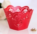 Close-up of red laser-cut cupcake wrappers with intricate vintage patterns for wedding decor - Pearlescent Red