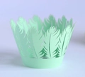 Close-up of laser-cut cupcake wrapper with light green pine tree and feather patterns - Fruit Green